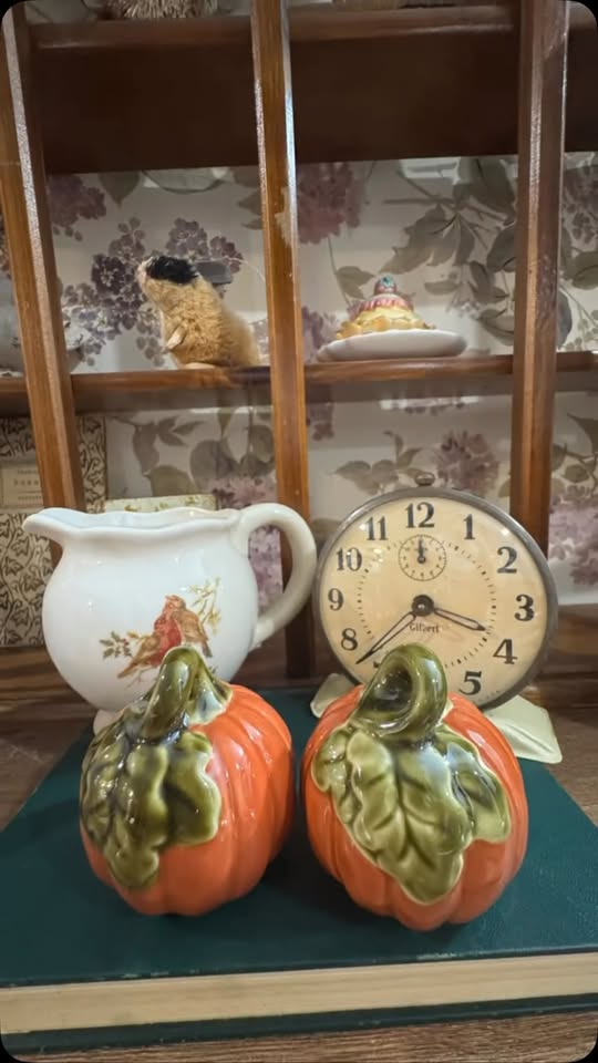Pumpkin-shaped containers, white pitcher with bird design, and clock